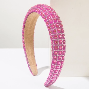 Detail of rose red padded headband featuring dense pink rhinestone and khaki suede lining