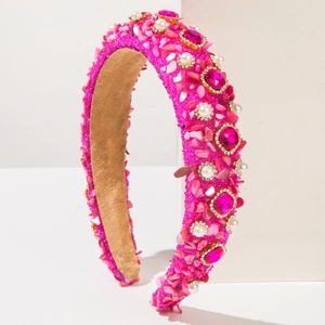 Nahaufnahme von rosa gepolstertem Haarreif mit Glaskristallen, Strass und Perlen