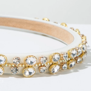 Detail of white satin headband featuring luxury large rhinestones and colorful beaded chain