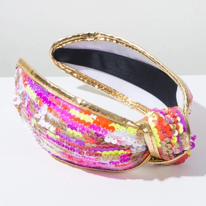 Close-up of colorful sequins and gold fabric piping on wide knotted headband