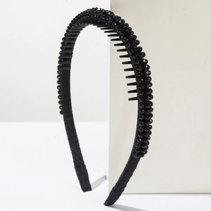 Detail of black beaded headband with anti-slip teeth and comfortable fabric ends