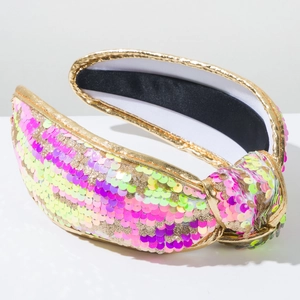 Detailed macro of sparkling knotted headband with colorful pink green and gold sequins
