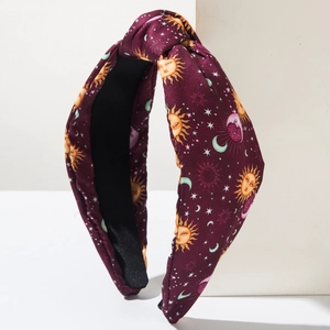 Vintage burgundy knotted headband featuring gold sun moon and star celestial prints