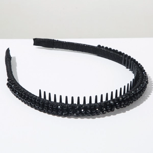 Detail of black beaded headband showing non-slip inner teeth for secure hair styling
