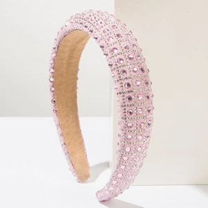 Close-up detail of luxury pink rhinestone padded headband with sparkling crystal surface