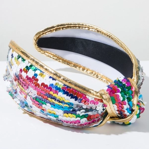 Detail of colorful sequins, gold fabric trim and anti-slip lining on knotted headband