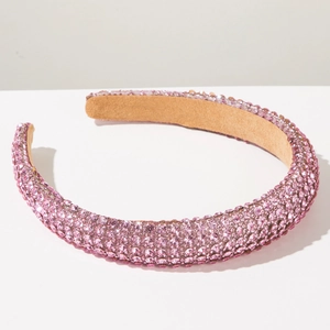 Detail of pink crystal rhinestones on padded headband with soft non-slip velvet lining