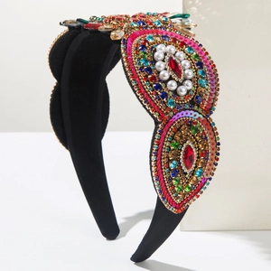 Detail of baroque headband featuring colorful rhinestones, pearls and sequins on black velvet