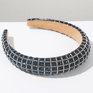 Detail of luxury padded headband with black rhinestones and white crystal lattice pattern