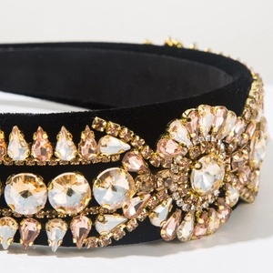 Detailed macro view of luxury black velvet headband with sparkling colorful rhinestones