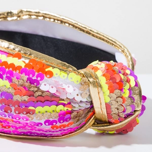 Macro shot of colorful sequins and gold metallic trim on this knotted headband
