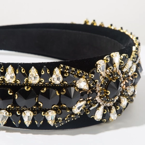 Macro shot of luxury velvet headband with intricate black crystal and rhinestone details