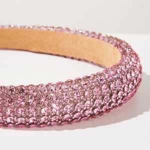Macro detail of the wide pink rhinestone sponge headband with non-slip suede lining