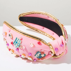 Detail of pink knotted headband with MOM lettering and sparkling rhinestone pearl accents