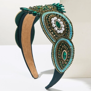 Detail of Baroque green velvet headband with emerald crystals and vintage white pearls
