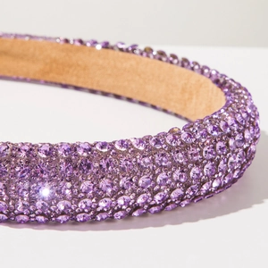 Detailed macro view of purple rhinestone headband with premium sparkling crystal inlay