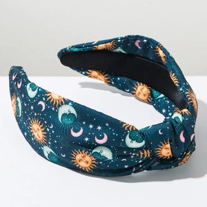 Close-up of knotted headband featuring sun moon celestial prints and non-slip lining