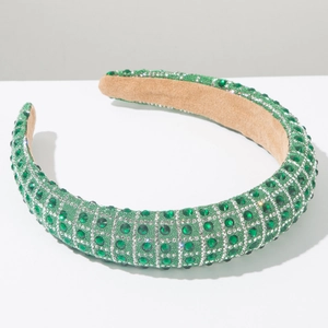 Close-up of luxury wide emerald green rhinestone headband with soft velvet inner lining