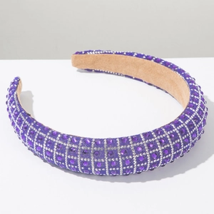 Detailed macro view of luxury purple rhinestone headband with intricate silver diamond grid pattern