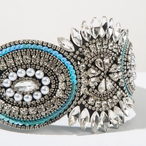 Detailed macro view of baroque headband with marquise rhinestones and white pearls