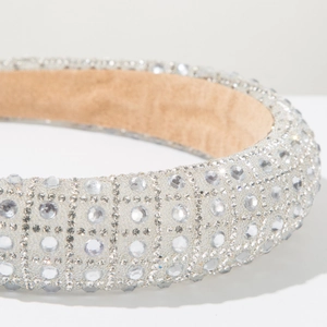 Close-up detail of luxury wide headband featuring densely inlaid sparkling crystals