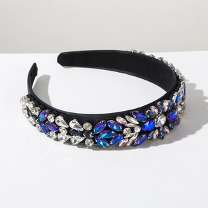 Detailed view of baroque rhinestone headband with crystals and pearls on black fabric