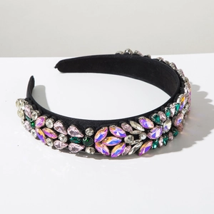 Detailed side view of a black velvet headband with colorful rhinestones and pearls