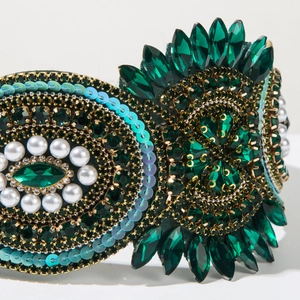 Macro shot of luxury emerald green crystal headband with pearls and baroque beads