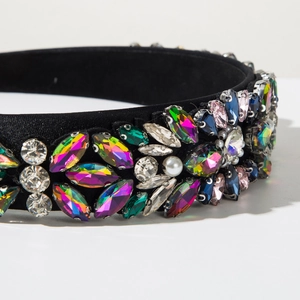 Detail of fabric headband with colorful rhinestones and pearls on black base