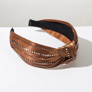 Detail view of brown satin knotted headband with four rows of sparkling square rhinestones