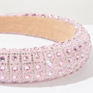 Macro detail of pink headband with sparkling crystals and luxury silver beadwork embroidery