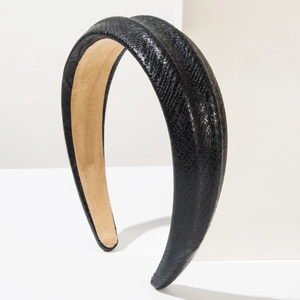 Detail of wide black faux snake leather headband with soft khaki velvet inner lining