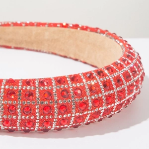 Macro shot of red crystal headband featuring thick padding and sparkling rhinestone gems