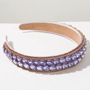 Detail of wide baroque headband with purple crystals and gold rhinestone trim edges