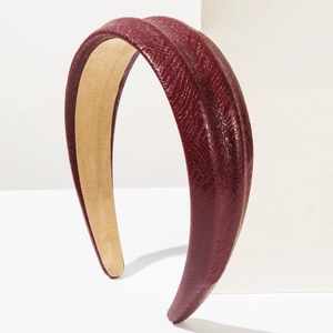 Detail shot of burgundy snakeskin texture headband with anti-slip beige velvet lining
