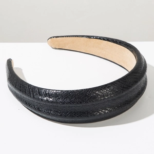 Detail of wide black faux leather headband with snake texture and non-slip lining