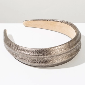 Macro detail of bronze snakeskin pattern headband with textured faux leather and wide design