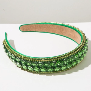 Close-up of green crystal baroque headband with faceted gems and suede non-slip lining