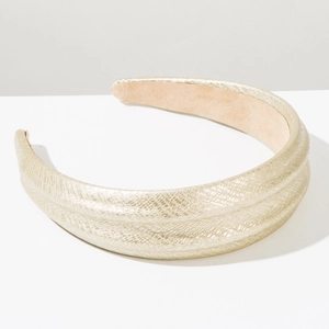 Detailed top view of wide light gold headband with snake texture and soft lining