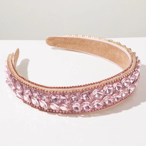 Detail showing pink oval rhinestones and golden base on a Baroque style headband