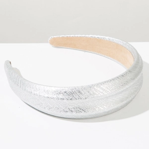 Close-up of silver snakeskin textured wide headband with soft beige suede lining