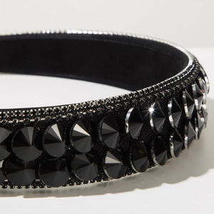 Macro shot of luxury black baroque headband with large multi-faceted crystals and fine diamond trim