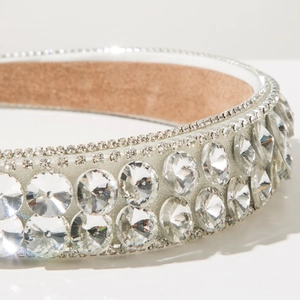 Close-up of wide baroque headband with double-row large crystals and silver frame
