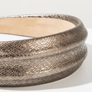 Close-up of bronze faux leather headband with snakeskin texture and beige suede lining