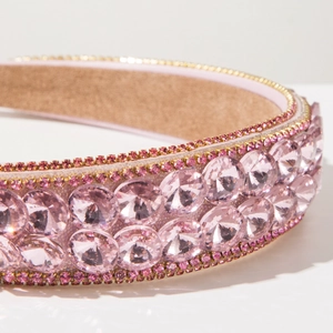 Macro shot of pink baroque headband featuring large crystals and intricate rhinestone edges