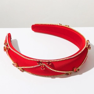 Detailed view of red velvet headband with silver diamond chains and red crystal gems