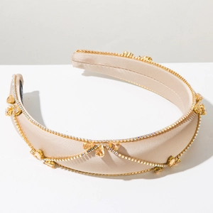 Detail of champagne satin headband with gold chain and amber gemstone embellishments