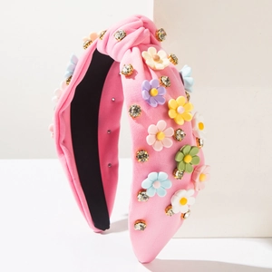 Detailed view of pink knotted headband with colorful resin flowers and sparkling crystals