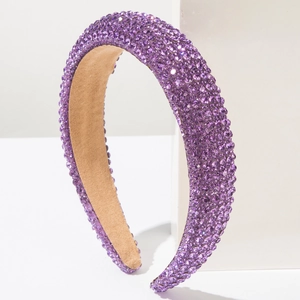 Détail d'un serre-tête rembourré violet orné de strass brillants et doublure douce