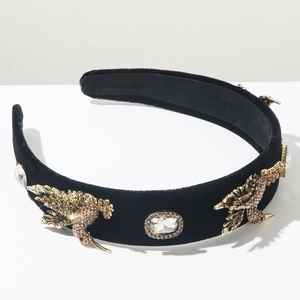 Detailed close-up of vintage Baroque headband with velvet texture and crystal birds